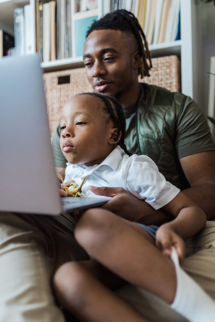 Father and child using a laptop computer